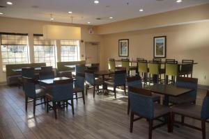 a dining room with tables and chairs and windows at Comfort Inn & Suites Burnet in Burnet
