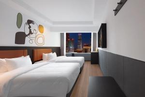 Postel nebo postele na pokoji v ubytování Mcsrh Hotel-Shenzhen Liutang