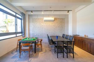 a dining room with a table and chairs at Namek Guesthouse in Luodong +24 photos