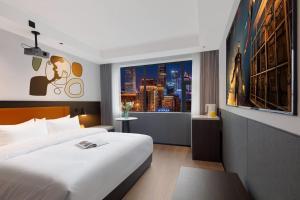 Postel nebo postele na pokoji v ubytování Mcsrh Hotel-Shenzhen Liutang