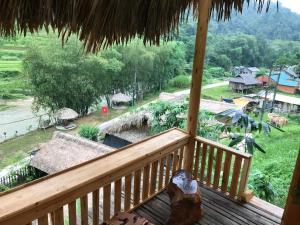 a balcony with a view of a village at Homestay Khoáng nóng Thông Nguyên in Nam Vong