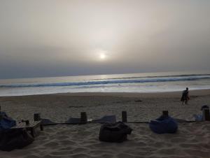a beach with a person walking on the beach at grange aménagée in Mimizan