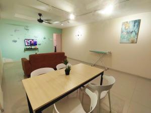 a room with a table and chairs and a couch at D'Ocean Marina Laguna Resort by Manhattan Group in Lumut