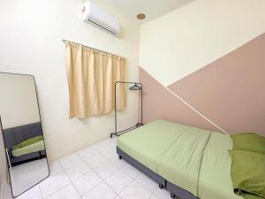 a hospital room with a bed and a mirror at Taiping Homestay Near Lakegarden in Taiping