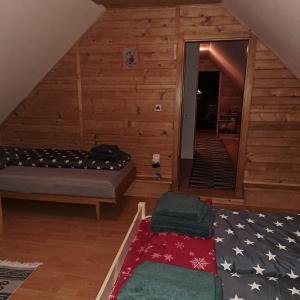 a attic room with a bed and an american flag rug at Drevenica Emma in Oravská Polhora