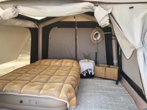 a bed in a tent with a table at Ecoclub in Varna City +157 photos