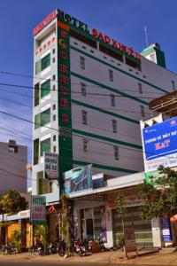 a large white building with a sign on it at Sao Khue 2 Hotel in Buon Ma Thuot