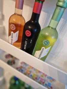 three bottles of wine sitting in a refrigerator at Ruhiges und großzügiges Appartement in Sankt Valentin +21 photos