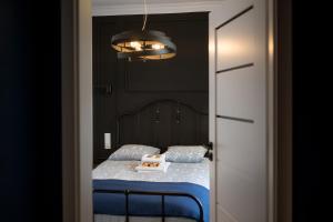 a bedroom with a bed with a book on it at Piernikowy i Cynamonowy Toruń z parkingiem in Toruń