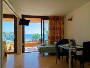 a living room with a table and a view of the ocean at Apart Ibiza Close to Hi & Ushuaia SEA FRONT in Illes Balears