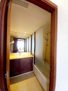 a bathroom with a sink and a mirror at Apart Ibiza Close to Hi & Ushuaia SEA FRONT in Illes Balears
