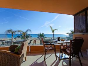 a dining room with a view of the beach at Apart Ibiza Close to Hi & Ushuaia SEA FRONT in Illes Balears