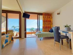 a living room with a bedroom with a view of the ocean at Apart Ibiza Close to Hi & Ushuaia SEA FRONT in Illes Balears