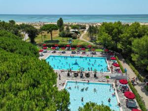 an overhead view of two pools with people in them at Il Tridente Camping Village in Bibione +26 photos