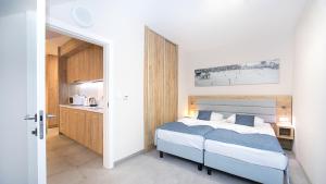 Ένα ή περισσότερα κρεβάτια σε δωμάτιο στο Aparthotel Panorama - Czarna Góra Resort, Sun & Snow