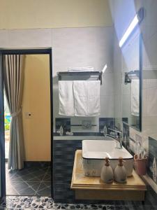 a bathroom with a bath tub and a sink at Hang Mua Green Retreat in Xuân Sơn +115 photos