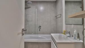 a bathroom with a shower and a sink and a tub at 105 Mossel Cove Unique & Trendy in Mossel Bay +10 photos