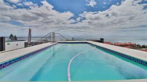 a large swimming pool on top of a building at 105 Mossel Cove Unique & Trendy in Mossel Bay
