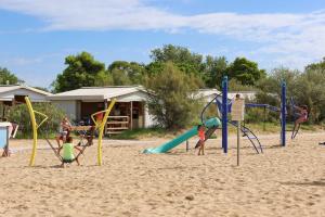 a group of children playing on a playground at Camping Village Capalonga in Bibione