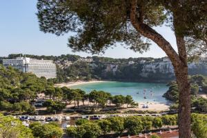 a view of a beach with people in the water at Apartamentos Alta Galdana in Cala Galdana