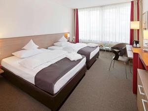 Postel nebo postele na pokoji v ubytování Mövenpick Hotel Münster am Aasee + 37 fotografií