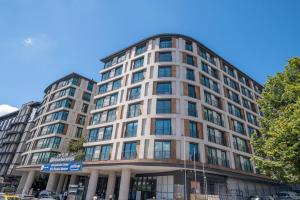 a tall white building with people in front of it at Luxury Apartments in Ofton Residence in Istanbul