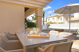a table and chairs on a patio with an umbrella at Villa Alyson in Paralimni +27 photos