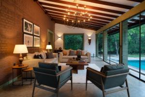 a living room filled with furniture and a chandelier at Neem Tree House in Kirinda