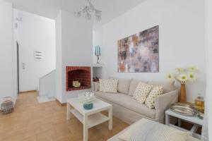 a living room with a couch and a fireplace at Casa Bianca Villa in Kolimbia