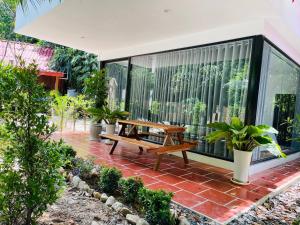 a patio with a wooden picnic table on a house at Holy Villa in Kampot