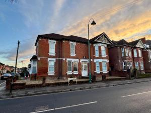 a large brick house on a city street at The Lodge Southampton in Southampton