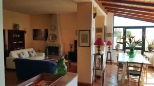 a living room with a couch and a table at Casa il Faro villa con piscina in Castelmola
