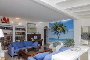 a living room with blue furniture and a view of the ocean at CHALET en la PLAYA CON PISCINA in Marbella