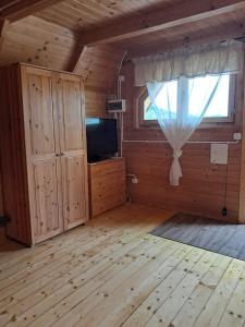 a large living room with a window and a television at Noclegi Korbielów in Korbielów