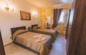 a room with two beds in a room at Villa Mercury in Żejtun +18 photos
