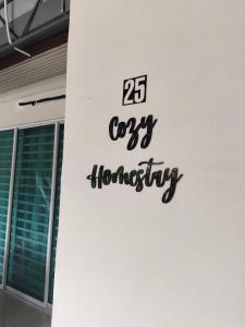 a sign on the side of a building at Cozy Homestay in Ipoh