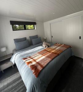 a bedroom with a large bed in a room at Pond Road Park - Raglan in Raglan