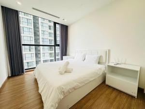 a bedroom with a large white bed with a large window at Vincom Plaza Vinhomes Sky Lake Phạm Hùng Mỹ Đình in Hanoi +63 photos