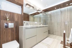 a bathroom with a white sink and a shower at Domek Konstancji w Pieninach z Klimatyzacją in Tylmanowa +94 photos