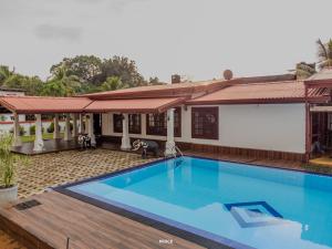 a large swimming pool in front of a house at Chamil villa in Galle