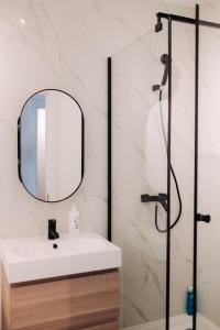 a bathroom with a sink and a mirror at Snagov Forest Villa in Ciolpani