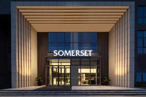 a building with a sign that reads somerset at Somerset Xuhui Riverside Shanghai serviced apartments in Shanghai