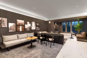 a living room with a couch and a table at Somerset Xuhui Riverside Shanghai serviced apartments in Shanghai