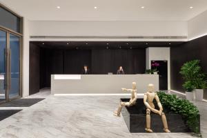 two mannequins in a lobby with a reception desk at Somerset Xuhui Riverside Shanghai serviced apartments in Shanghai
