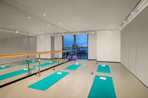 a swimming pool with turquoise mats at Somerset Xuhui Riverside Shanghai serviced apartments in Shanghai