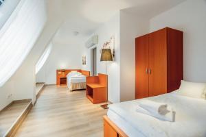 Postel nebo postele na pokoji v ubytování Wine Wellness Hotel Amande Hustopeče