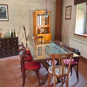 a dining room with a glass table and chairs at Casa Rural El Montaraz de Gema in Gema