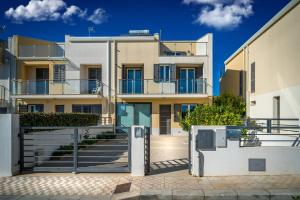 an apartment building with stairs in front of it at Avola Sun & Sea Sicily in Avola
