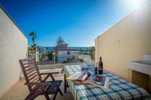 a table and chairs on a patio with a view of a balcony at Avola Sun & Sea Sicily in Avola