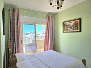 a bedroom with a bed and a window with a view at Sunny Beach Penthouse 271 in Lalzit Bay +27 photos